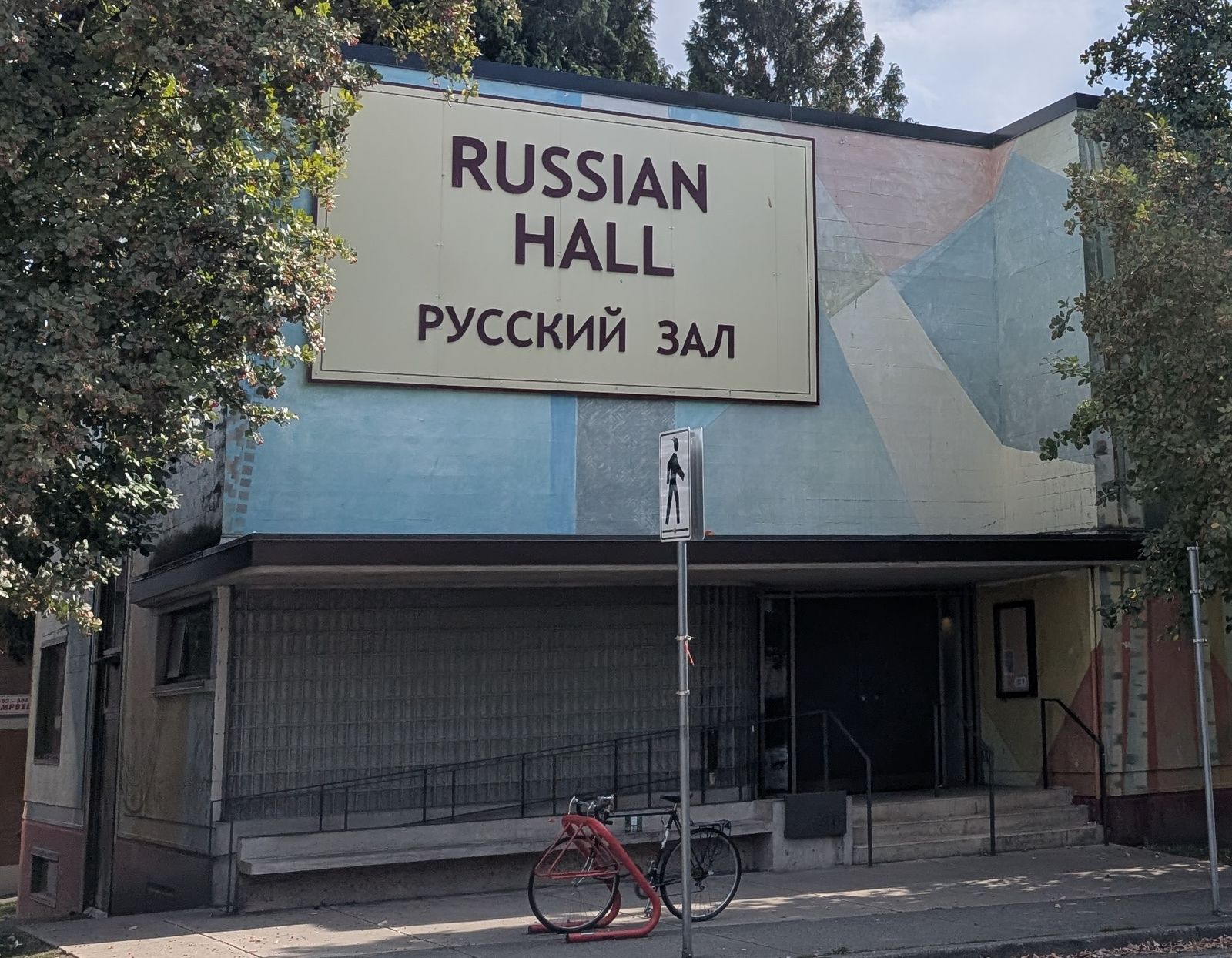 The front of the Russian Hall on Campbell Avenue, with its cream sign reading Russian Hall and Русский зал above the entrance